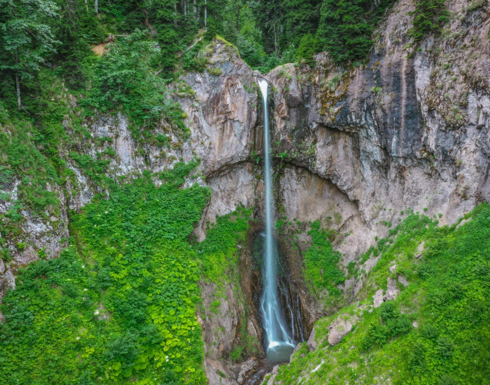 Afurja waterfall surrounded by rocky terrain